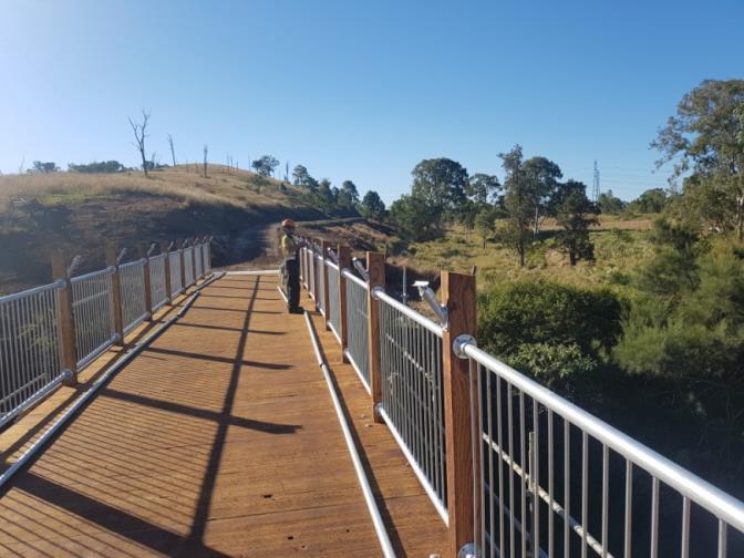 Jimmy's Gully Mass Timber Pedestrian bridge apart of Rails to trails program in  Australia. Designed by Wood Research and Development and constructed and manufactured by Timber Restoration Services.