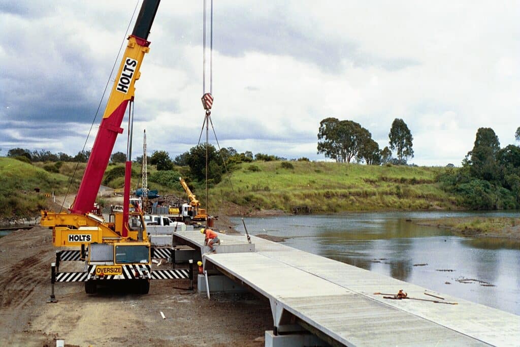 Crane hoisting a section into place at a Doolan Deck bridge