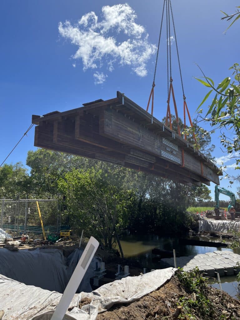 Crane hoisting the prefabricated River Road Bridge kit